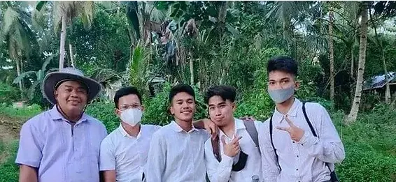 Five men in white shirts standing together with jungle behind them